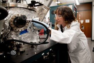 Jean Anne Incorvia tends to a machine in a lab